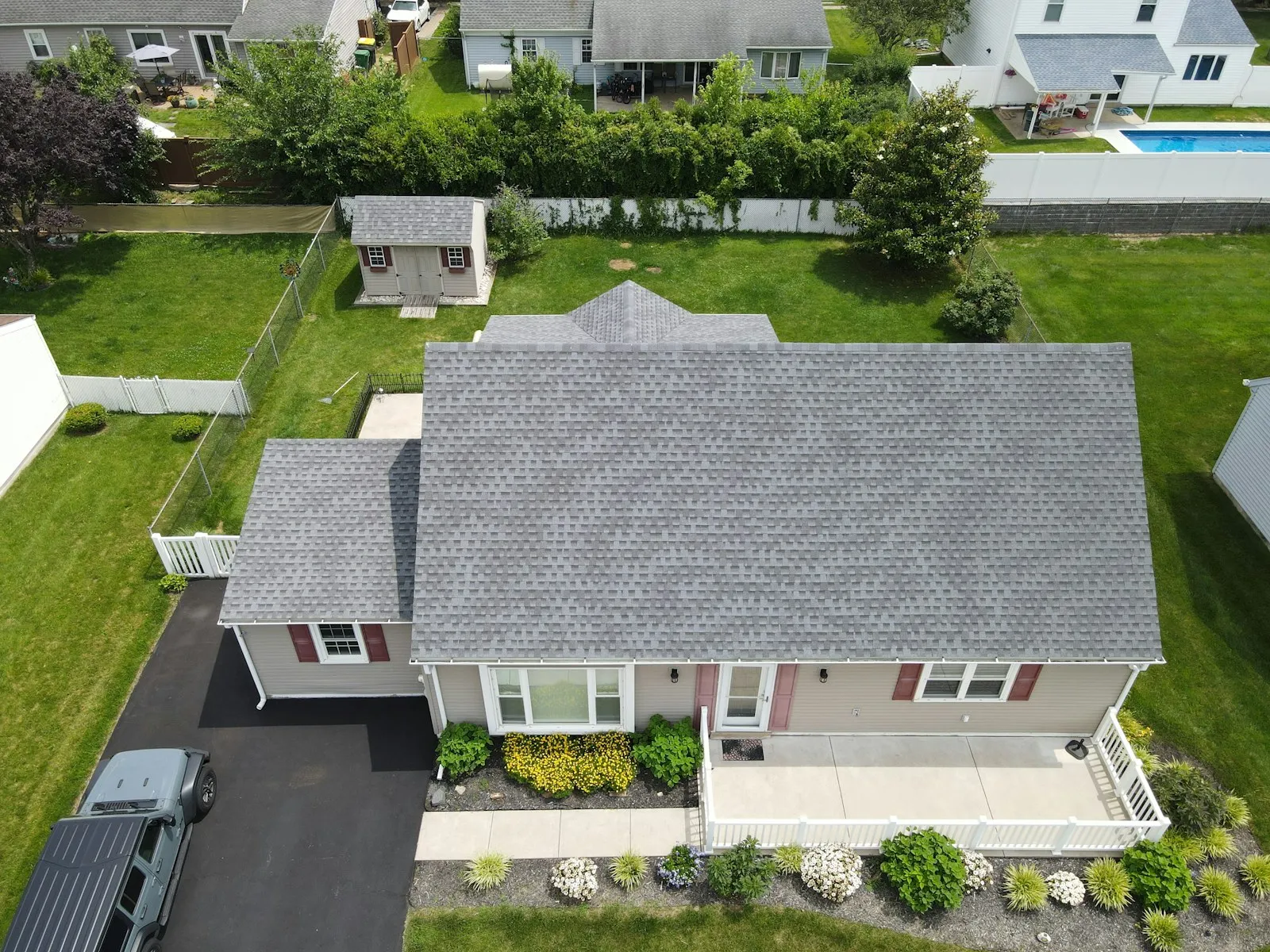 Aerial view of a completed re-roof on a Perth home with fresh grey roofing